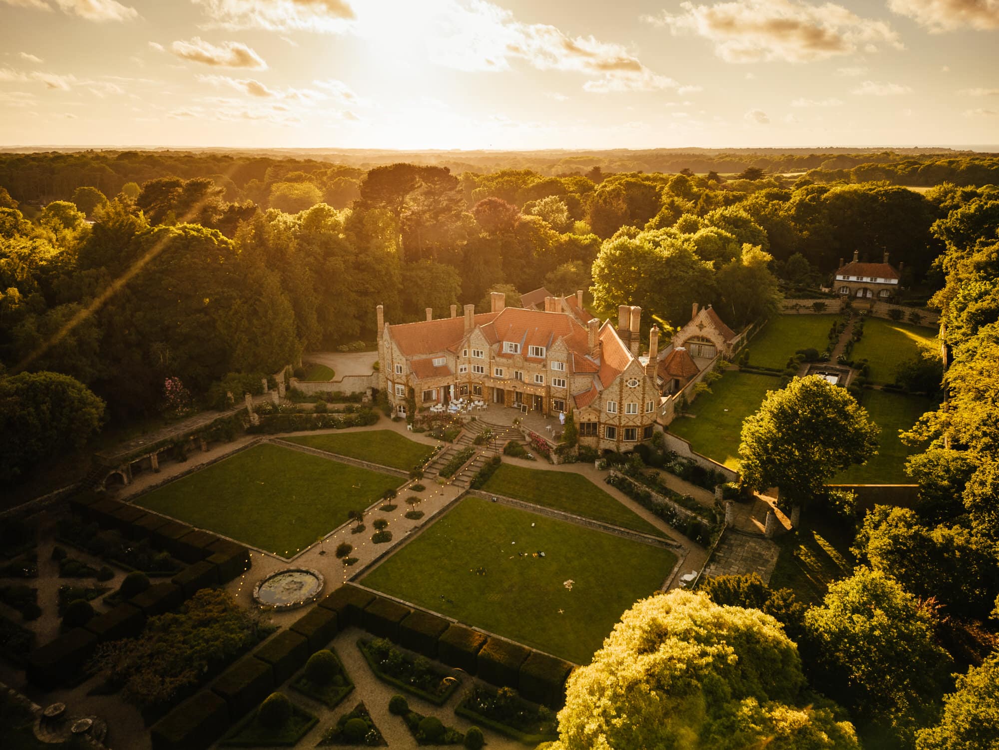 Aerial view of Voewood - elegant historic manor with gardens at sunset