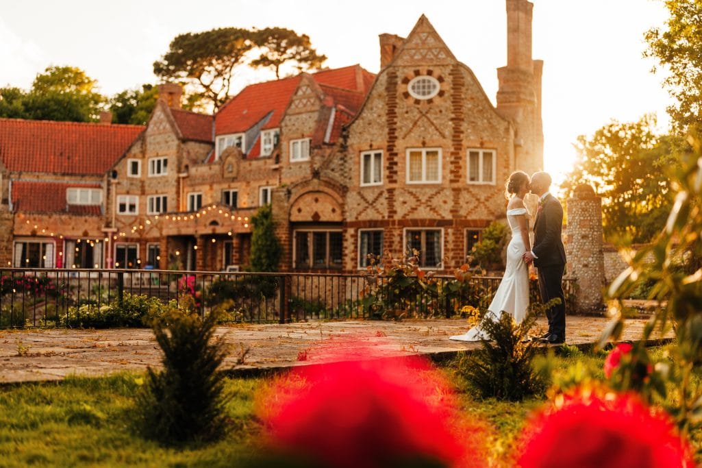 Voewood wedding Couple kissing at sunset, historic estate wedding.
