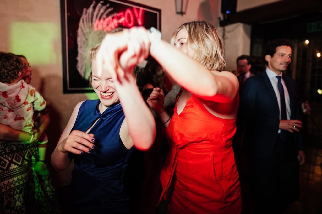 Women dancing joyfully at festive occasion