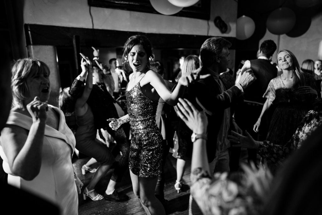 Voewood wedding photography - guests dancing at a party, black and white