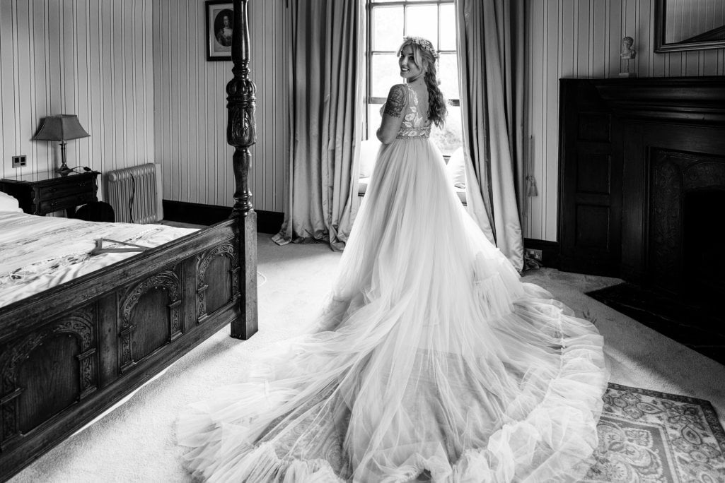 Bride in vintage room, elegant wedding dress, black and white.