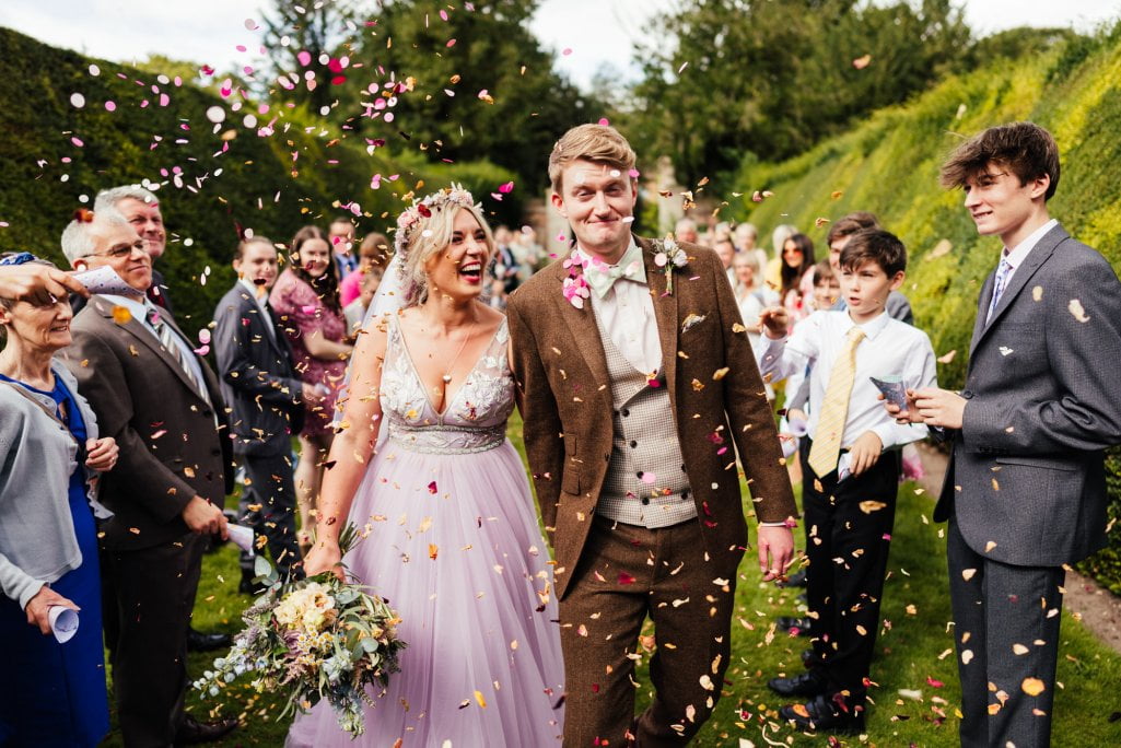 Bride and groom with confetti at wedding celebration