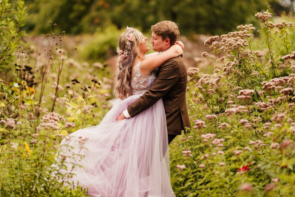 Couple embracing in a flower field.