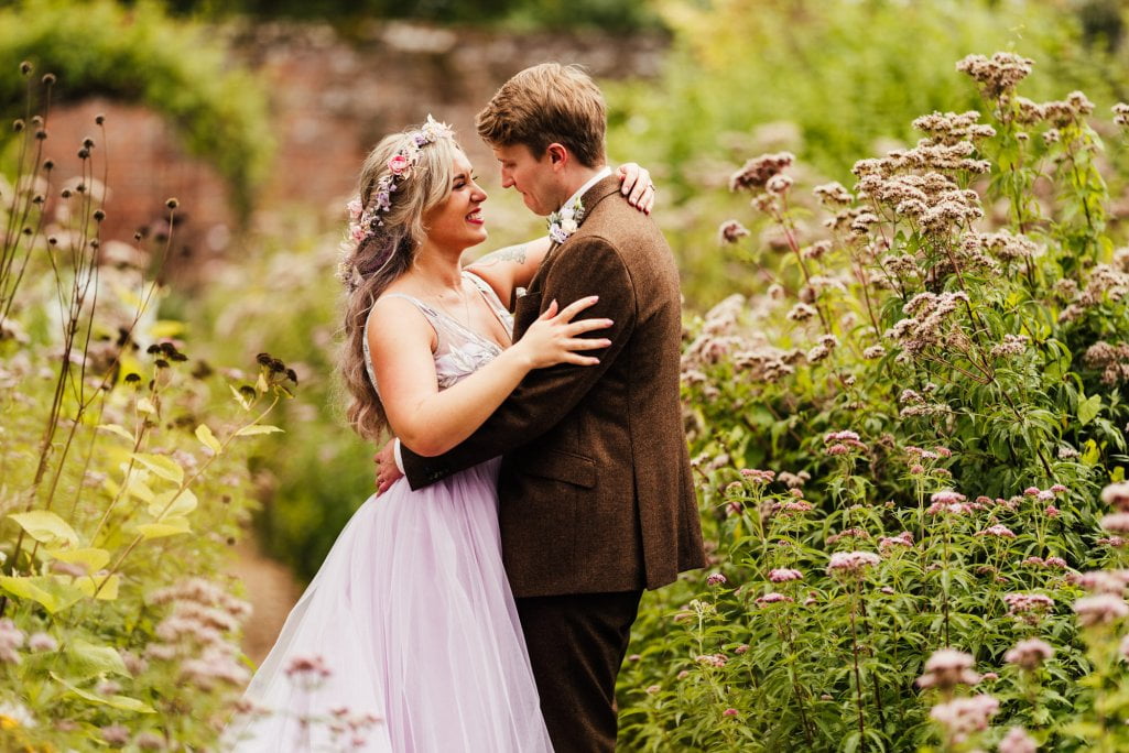 Couple embracing in a blooming garden.